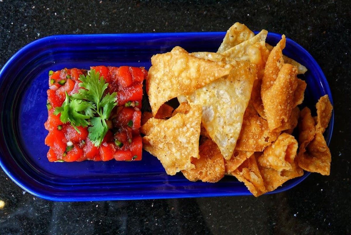 a plastic container filled with different types of food on a blue plate