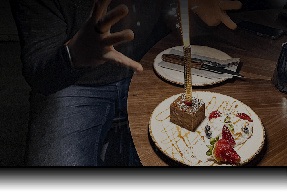 a person holding a piece of cake on a plate