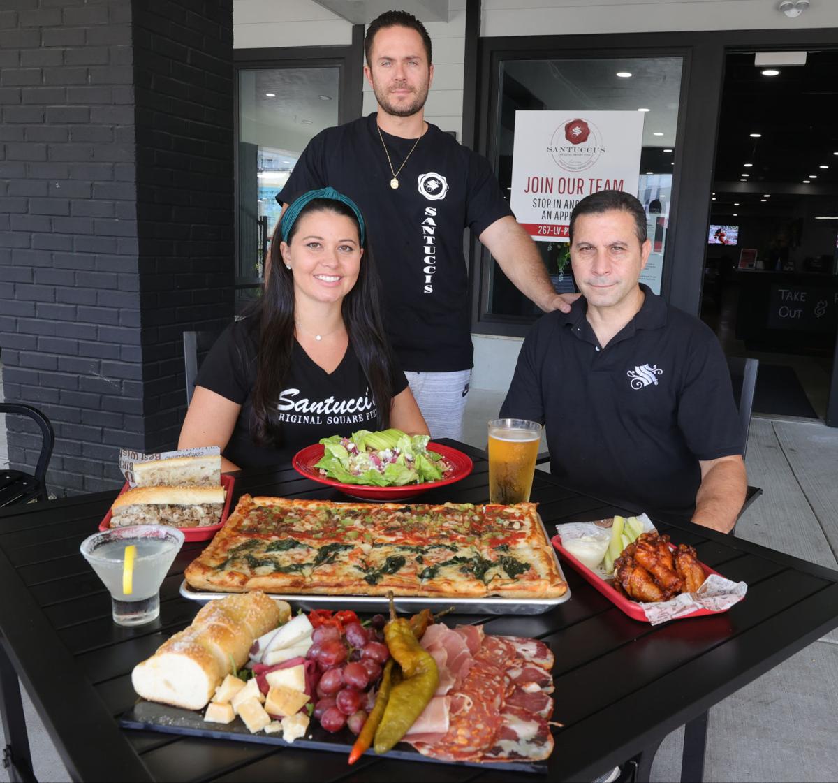 Blake, Frank Sr. and Alicia displaying some of their most popular menu items