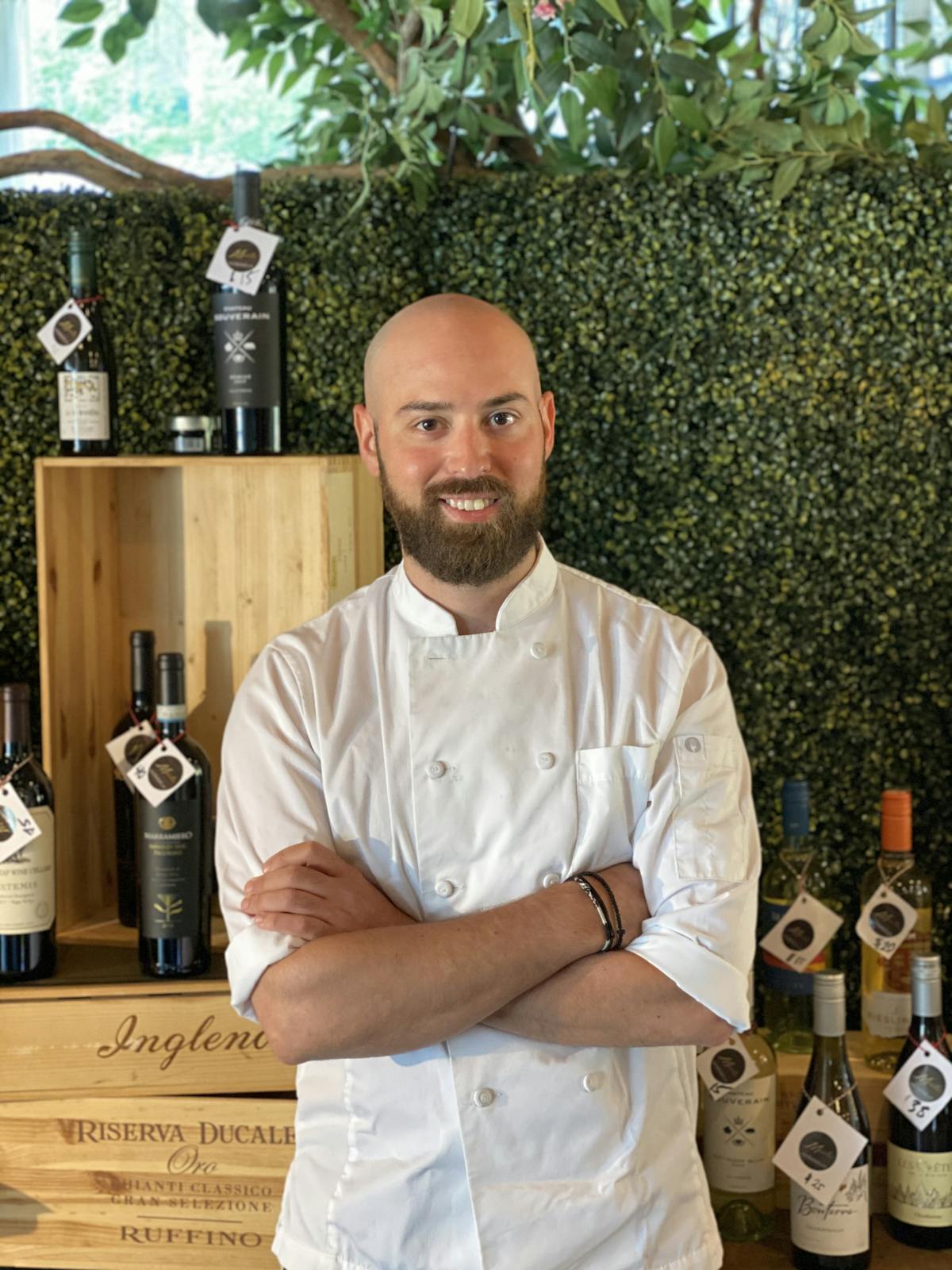 a man holding a bottle of wine