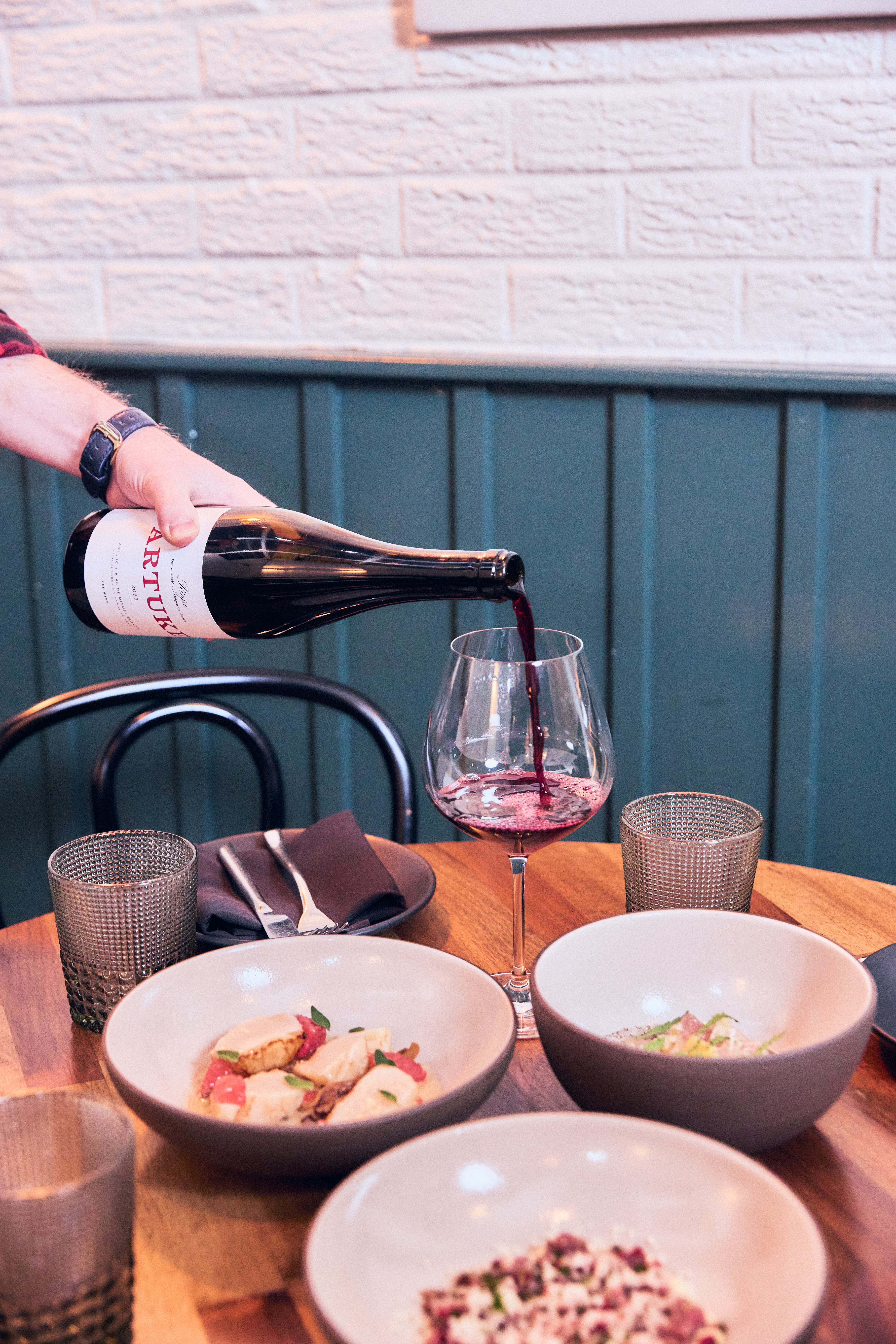 a person sitting at a table with a plate of food