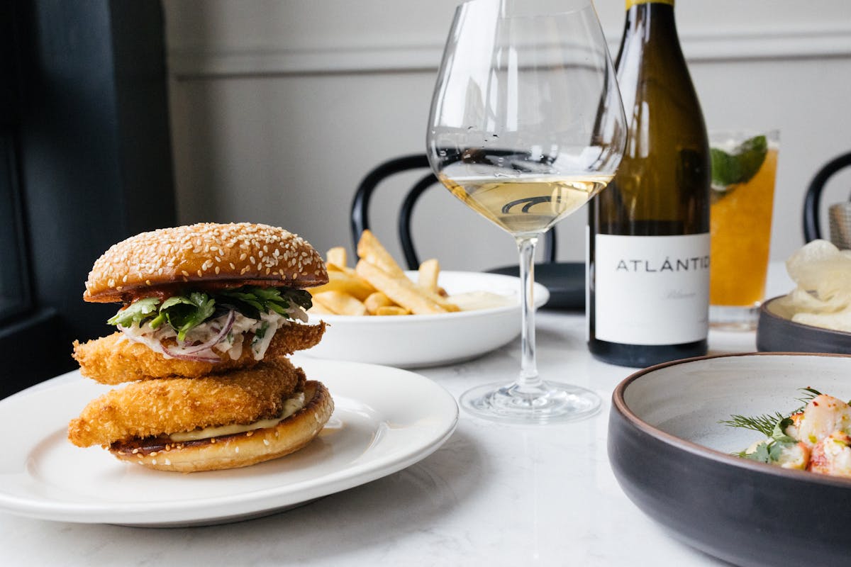 a plate of food and a glass of wine