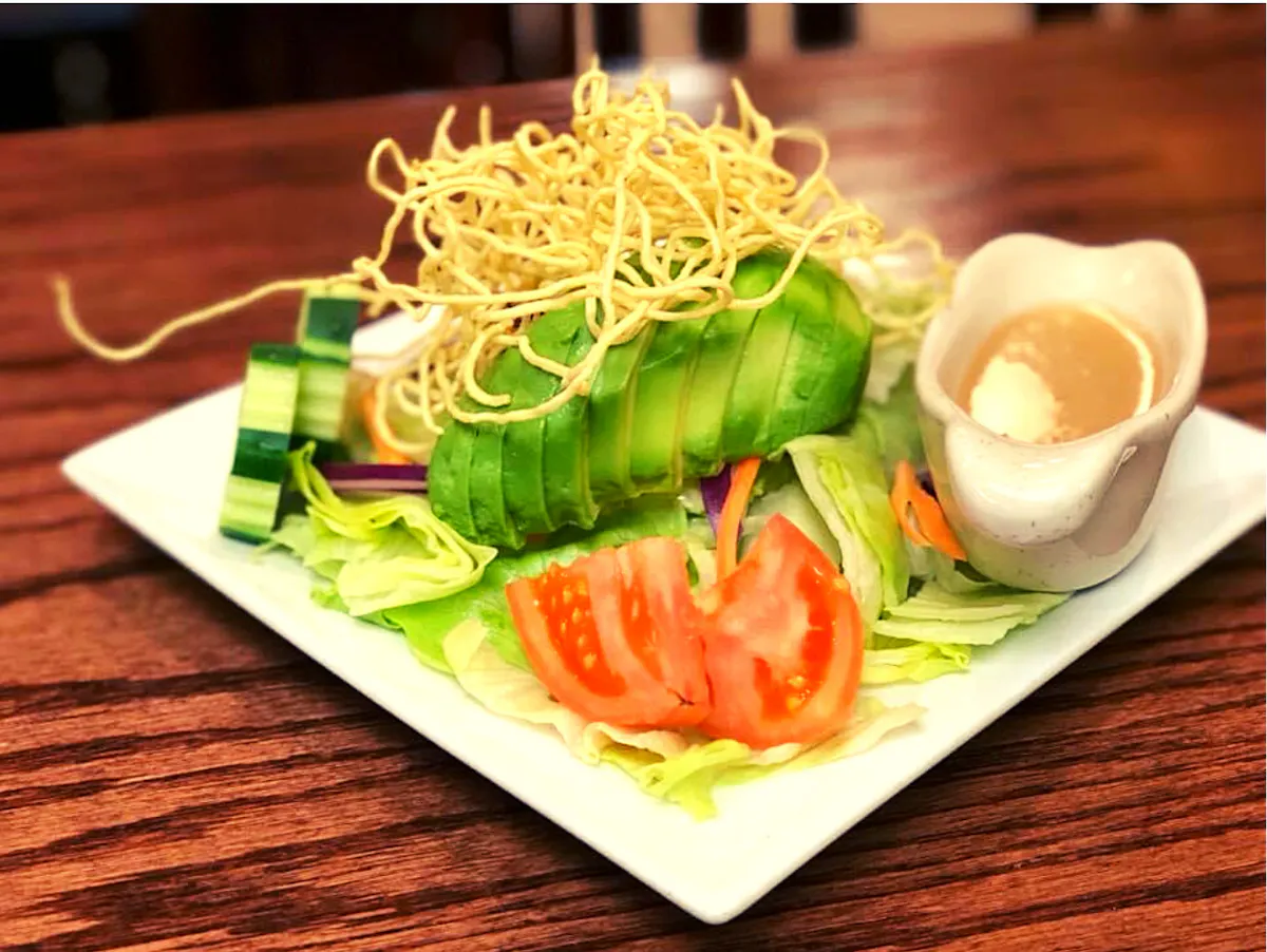 a plate of food on a wooden table