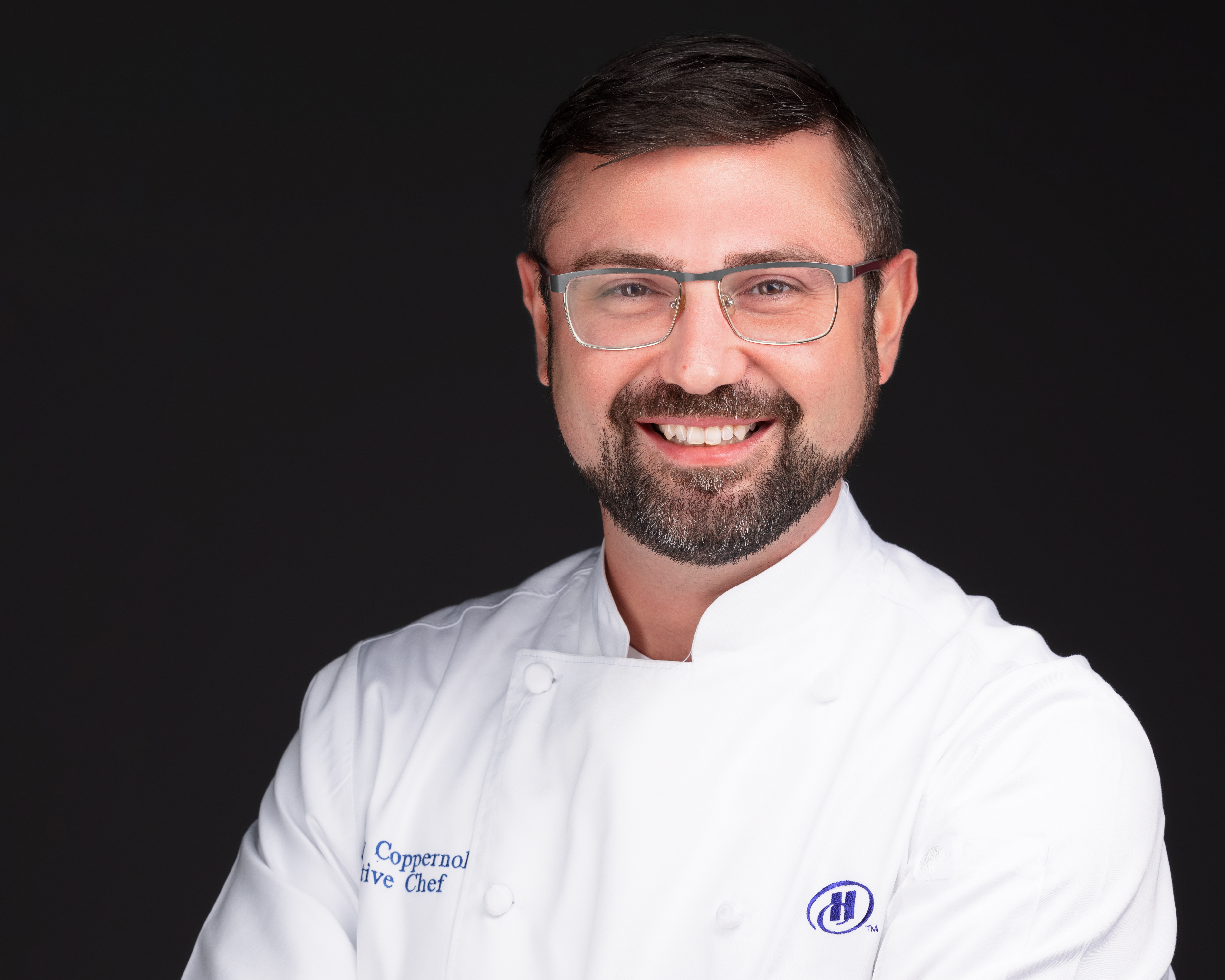 a man wearing glasses and looking at the camera