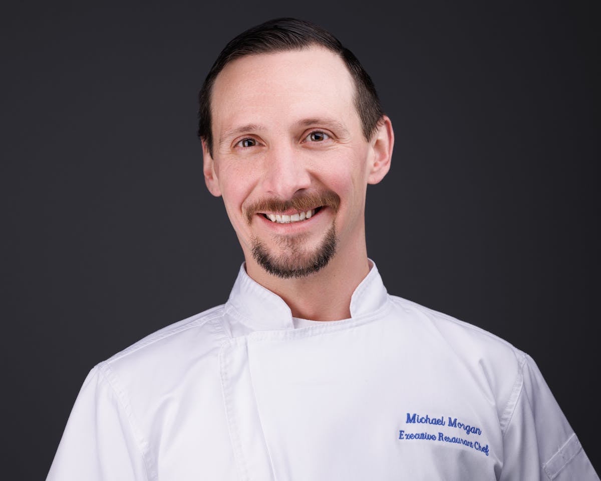 a man wearing a white chef's shirt.