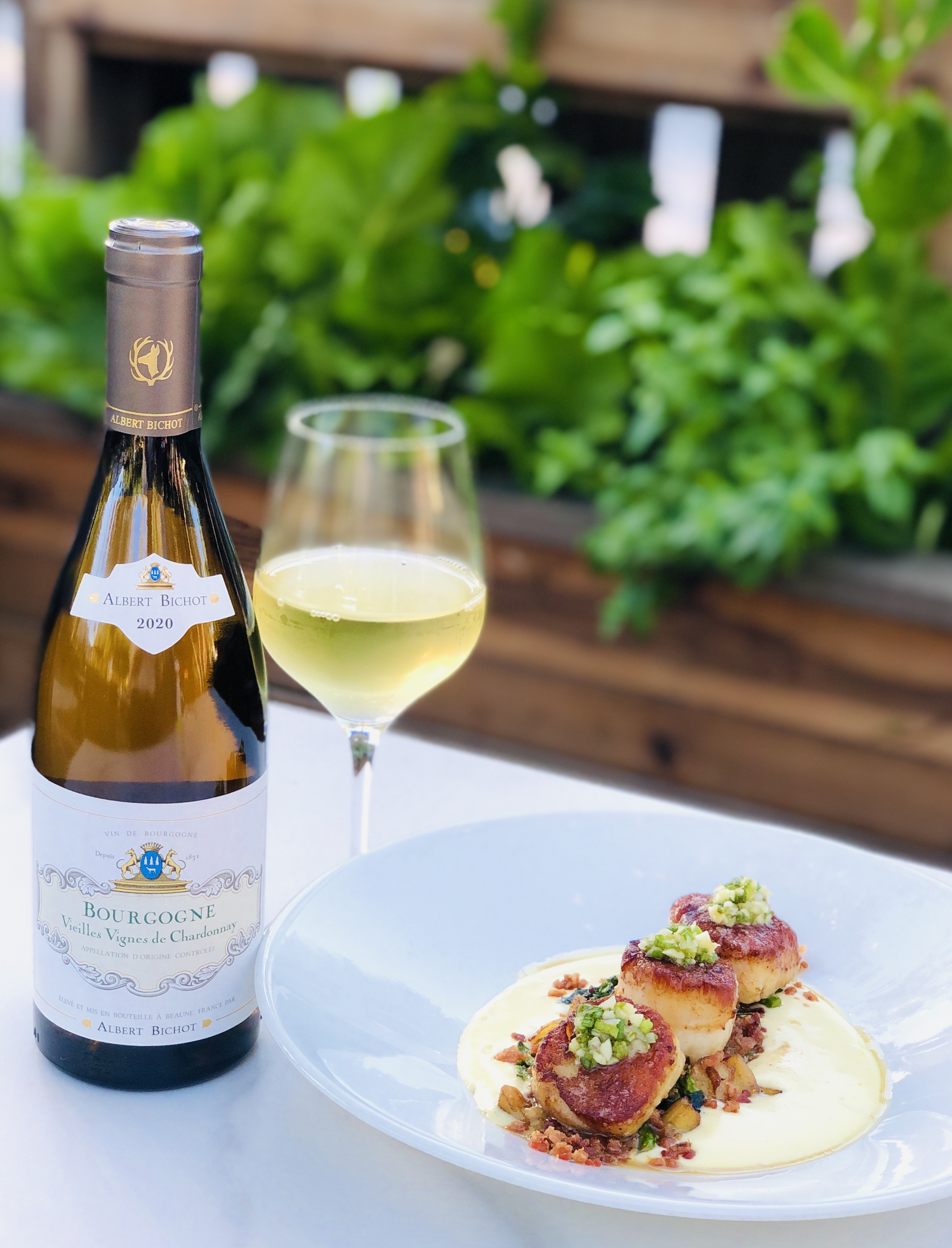 a plate of food and a bottle of wine on a table