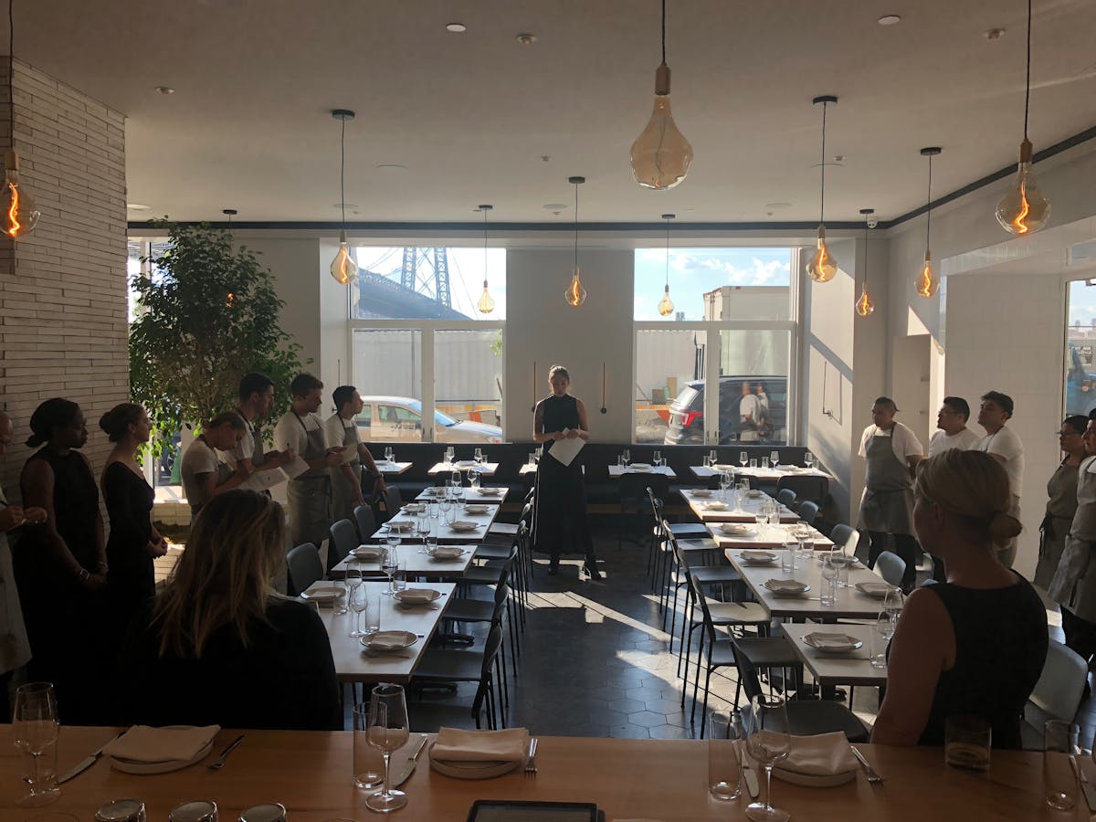 a group of people sitting at a table with wine glasses