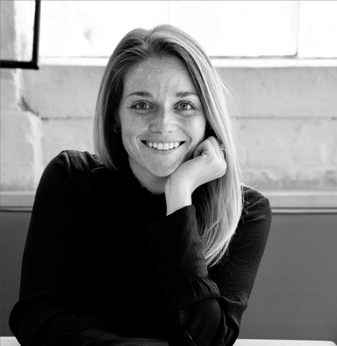 a woman sitting in front of a window