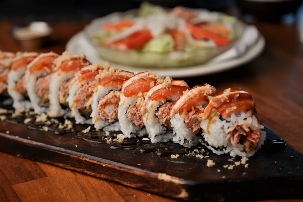 multiple slices of sushi laying on a wooden table