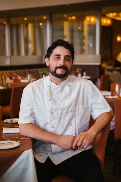 a man sitting at a table in a restaurant