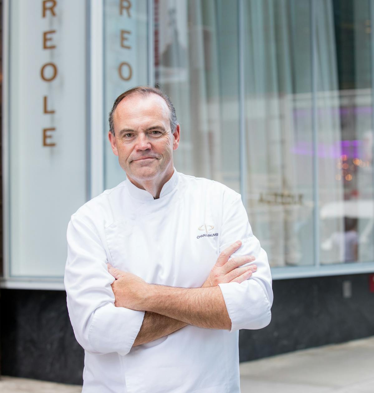 Charlie Palmer standing in front of a building