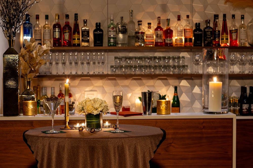 a bottle of wine glasses on a table