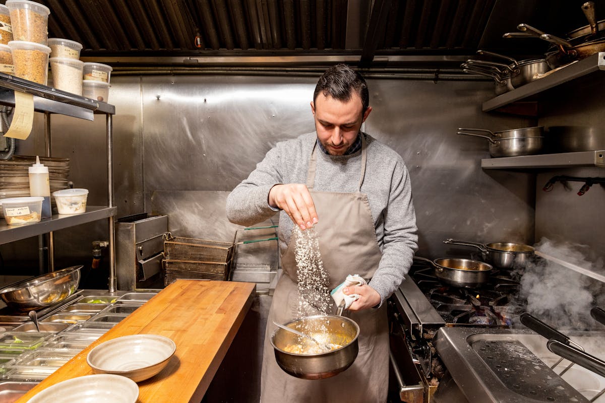 a man cooking in a kitchen preparing food
