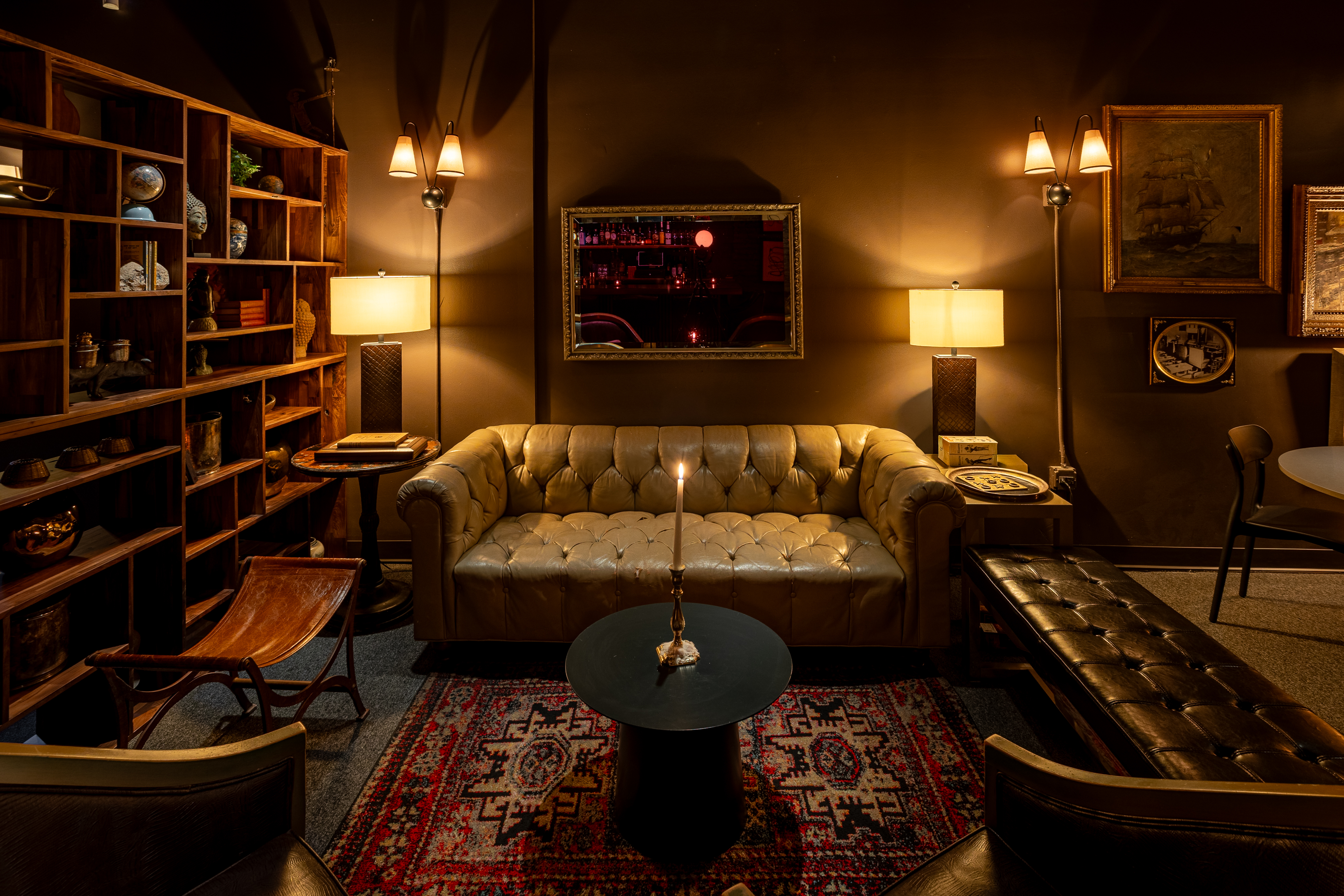a room with a couch and a table and lamp