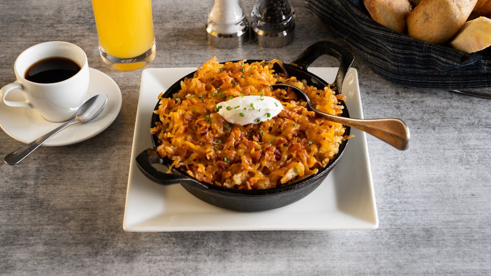 a plate of food and a cup of coffee on a table