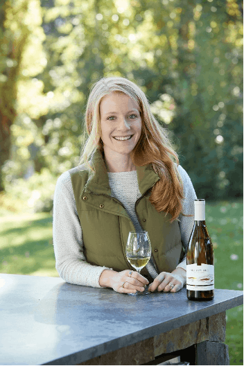 a woman sitting at a picnic table