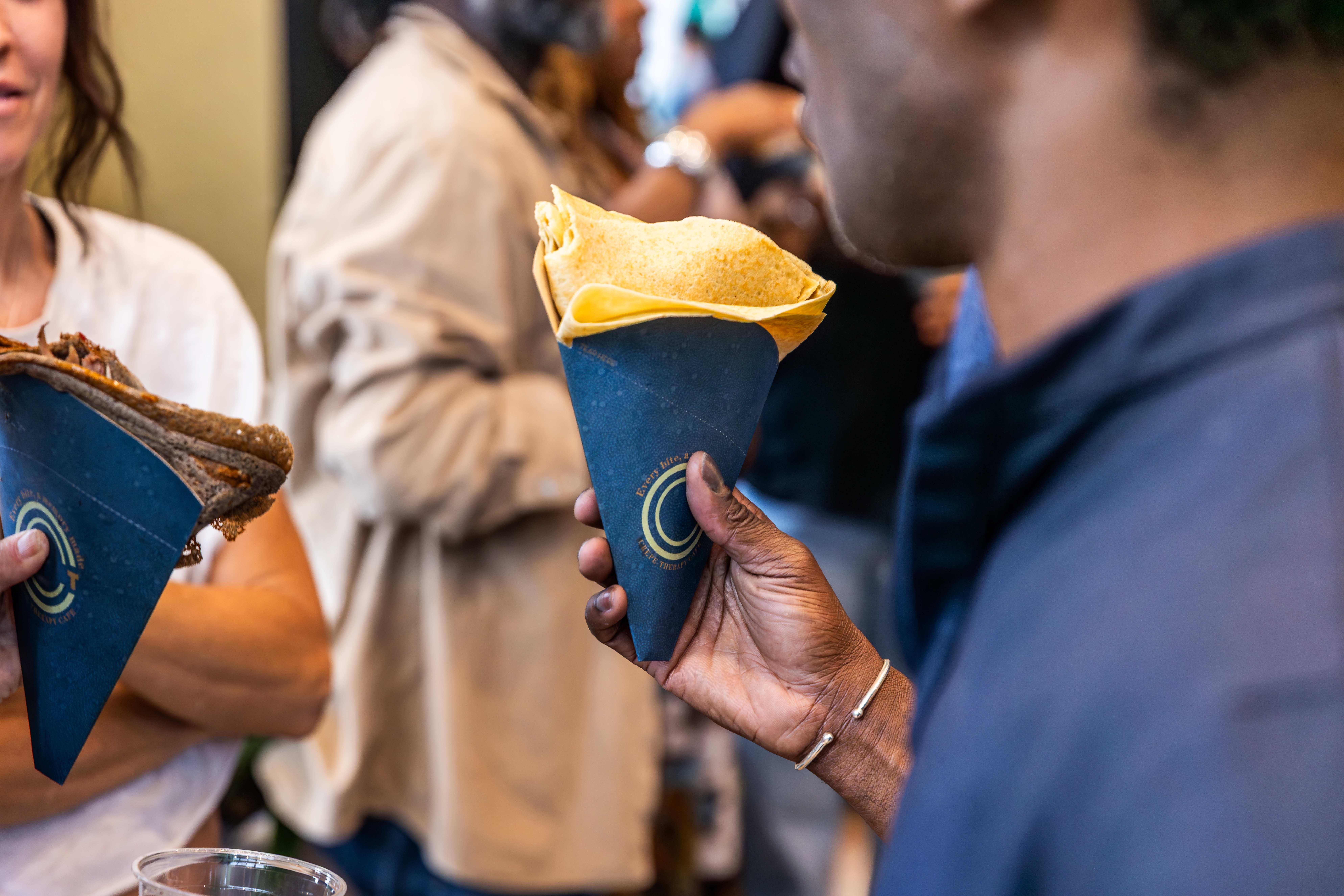 a man holding a tortilla cone
