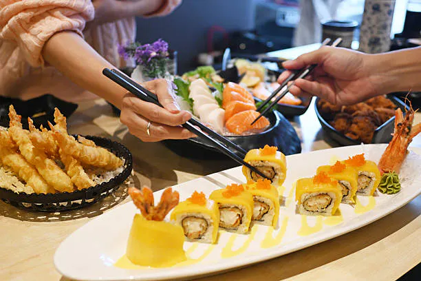a person sitting at a table with a plate of food
