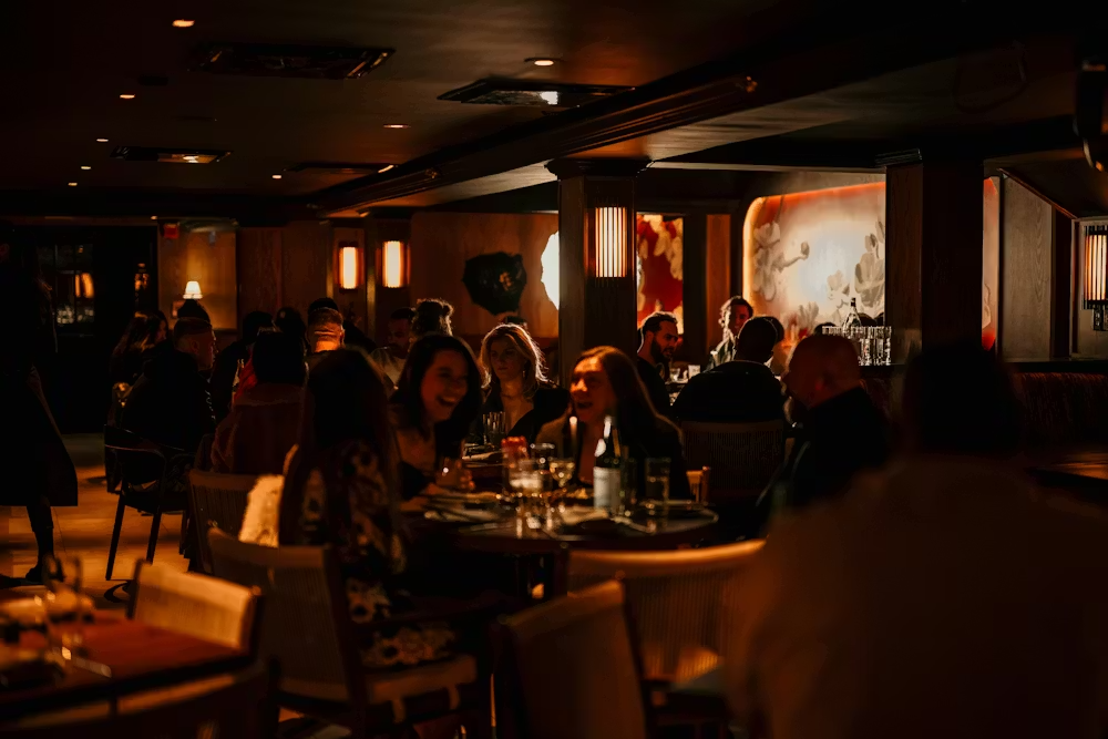a group of people sitting at tables in a restaurant