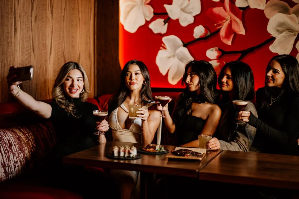 a group of women sitting at a table with drinks