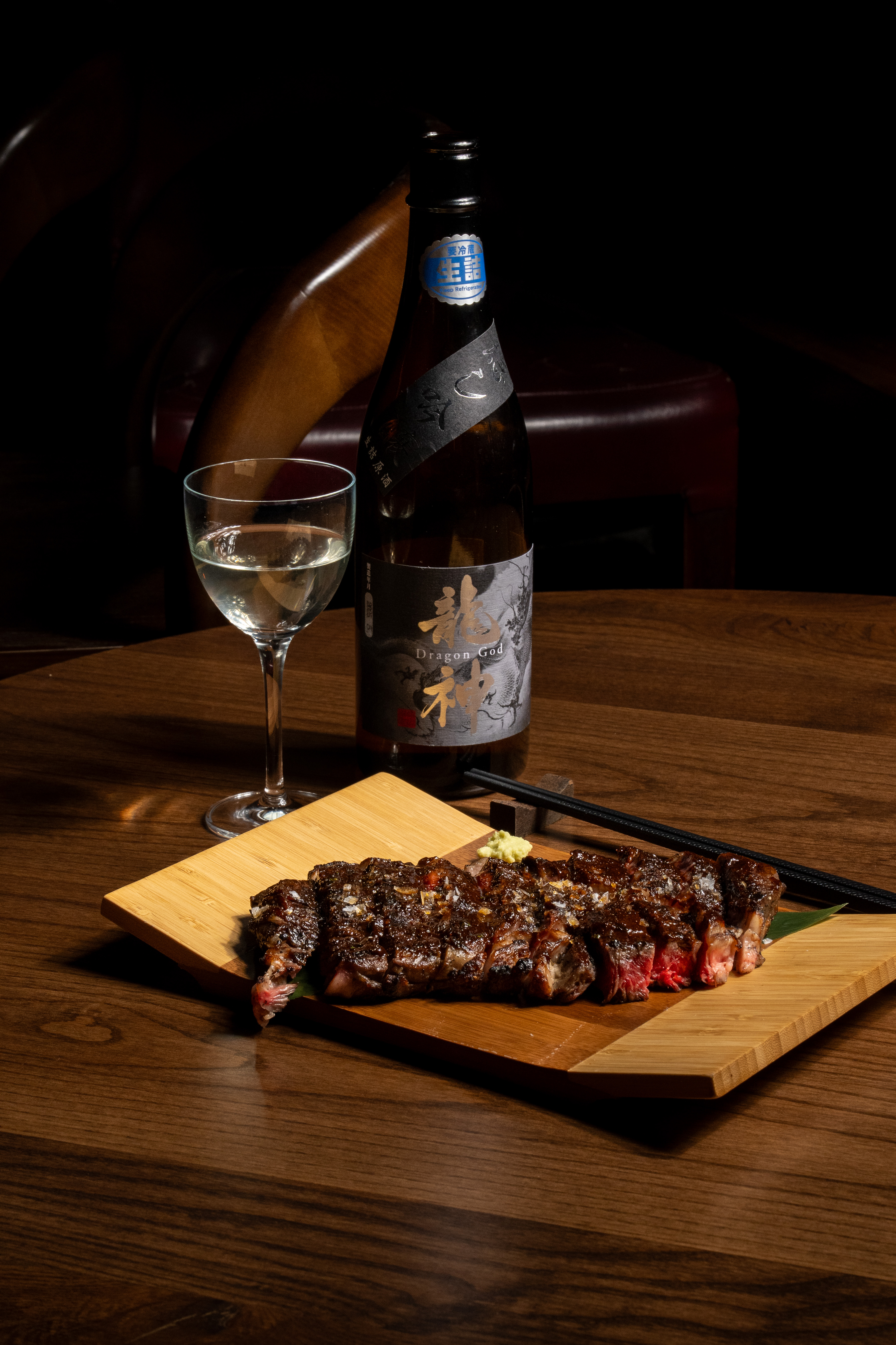 a glass of wine sitting on top of a wooden table