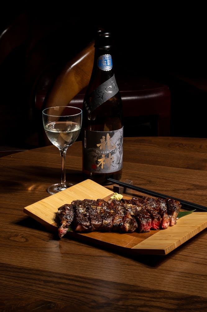 a glass of wine sitting on top of a wooden table