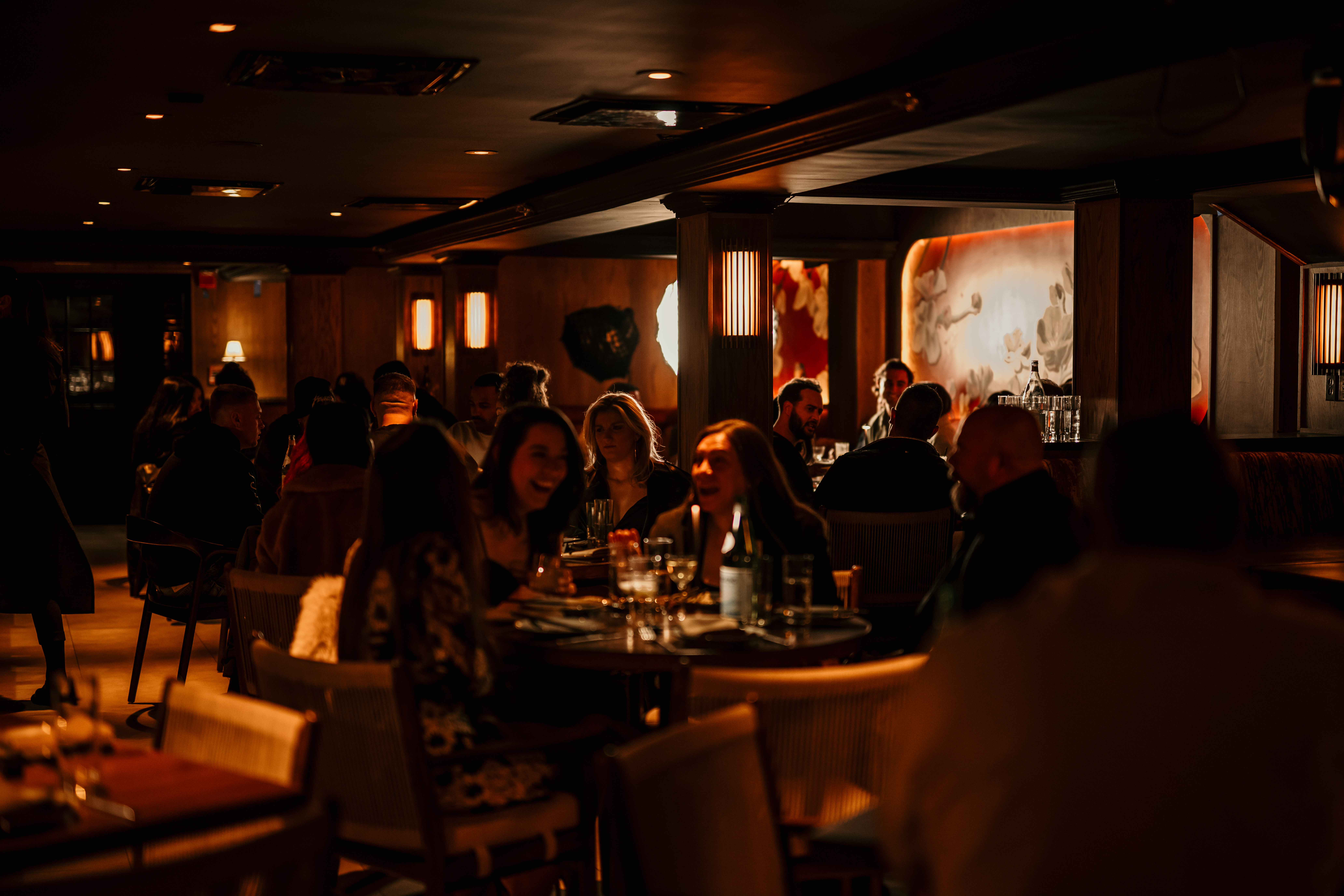 a group of people sitting at a table in a restaurant