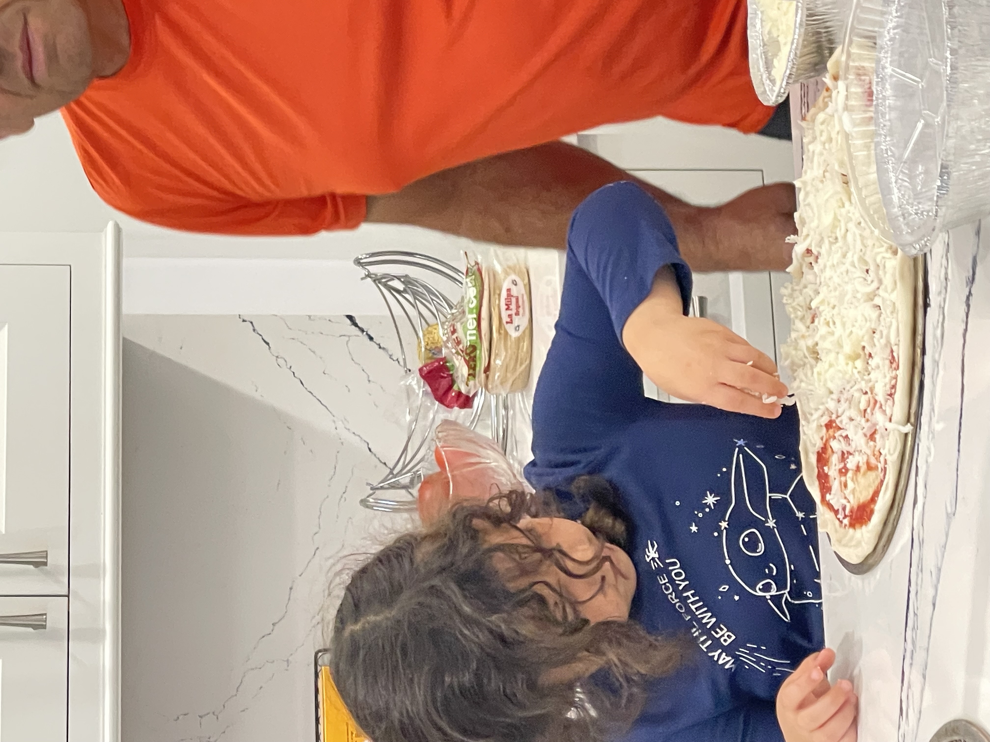 a person standing in front of a pizza