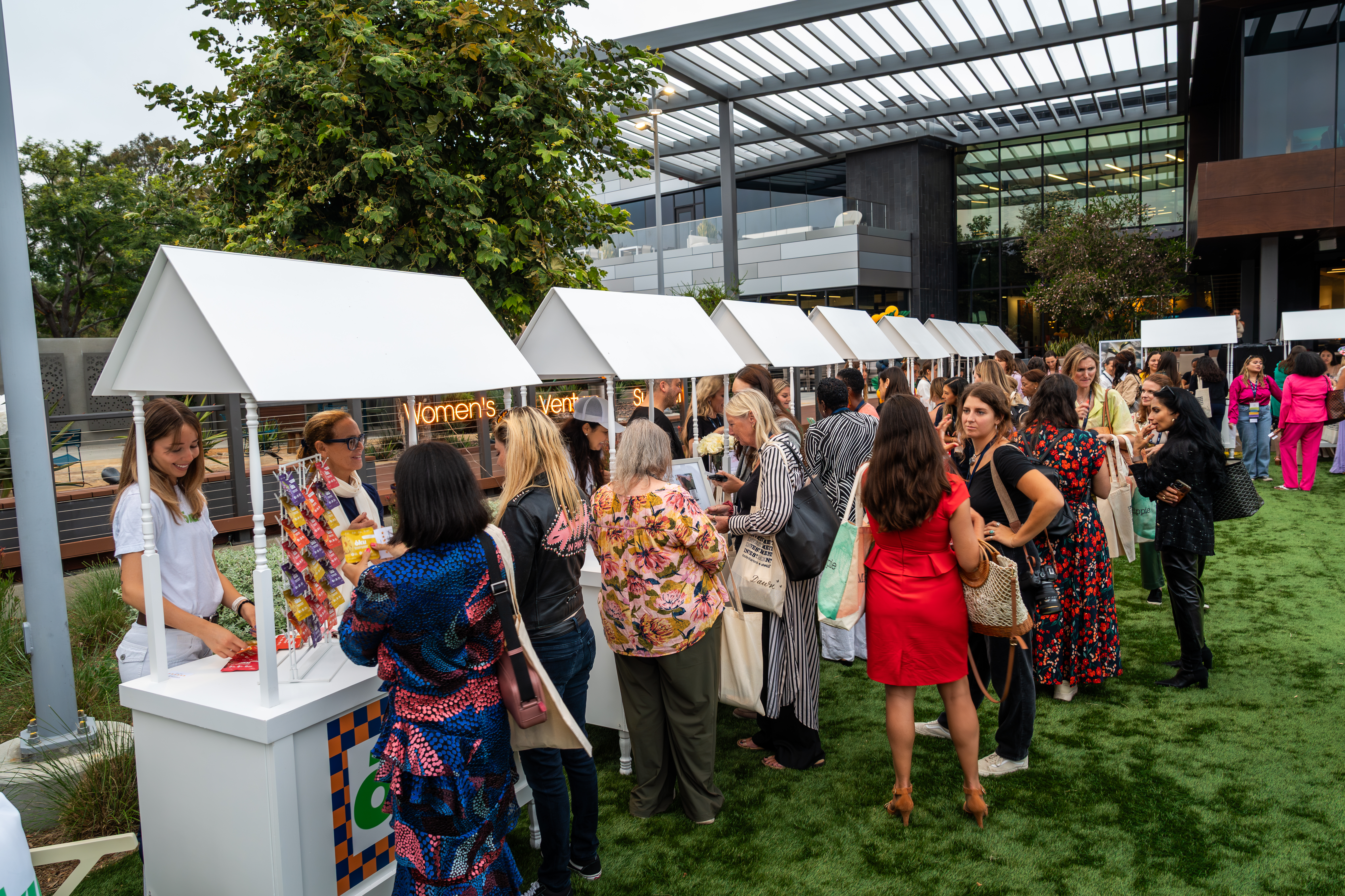 Guests moving through an outdoor private event on the Joya Kitchen lawn.