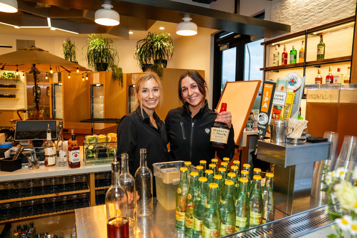 a person sitting at a table with wine glasses