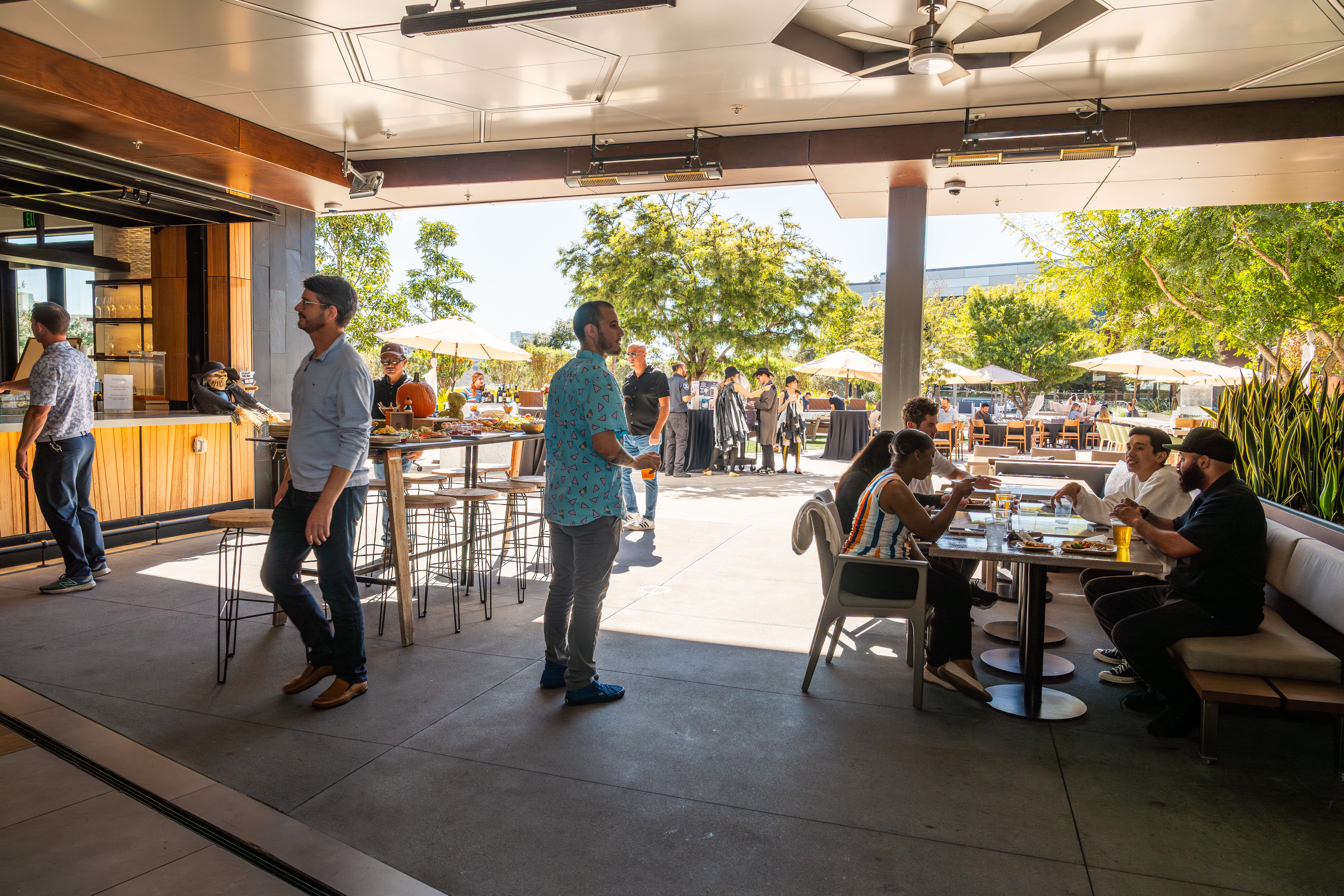 Guests socializing at an indoor-outdoor themed event at Joya Kitchen.