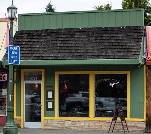 Front view of Trillium with green storefront and yellow trim