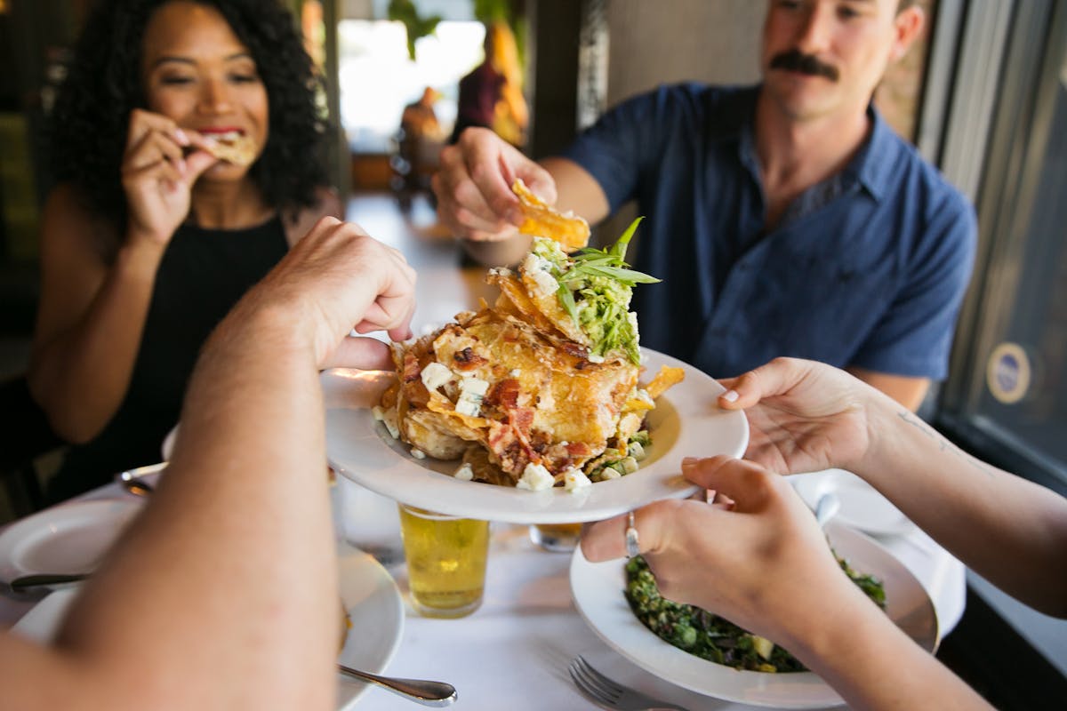 a woman sitting at a table eating food