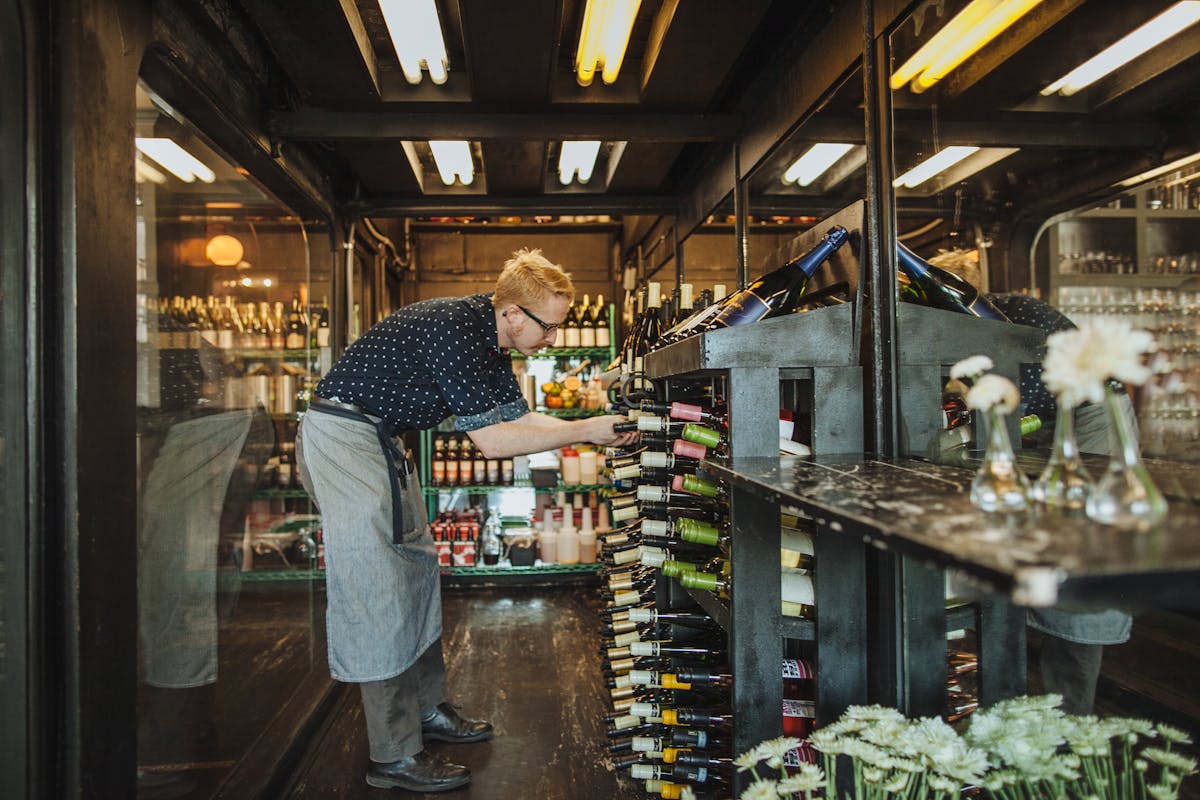 a man standing in front of a restaurant