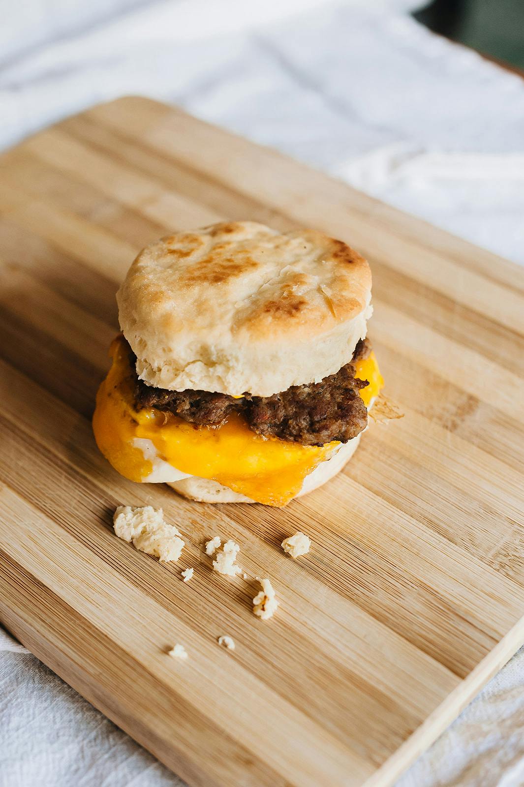 a biscuit sandwich on a cutting board