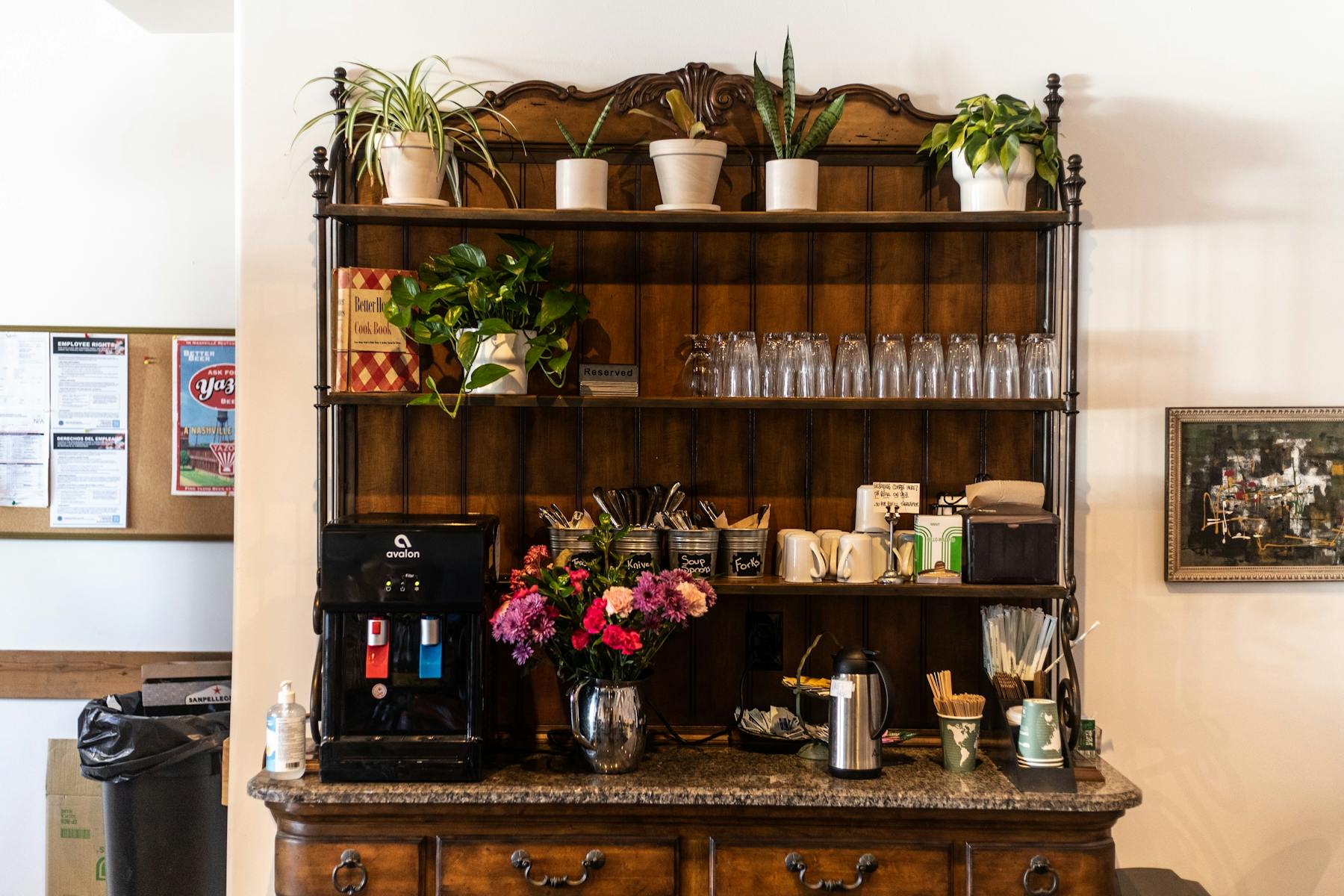 a room filled with furniture and vase of flowers on a table