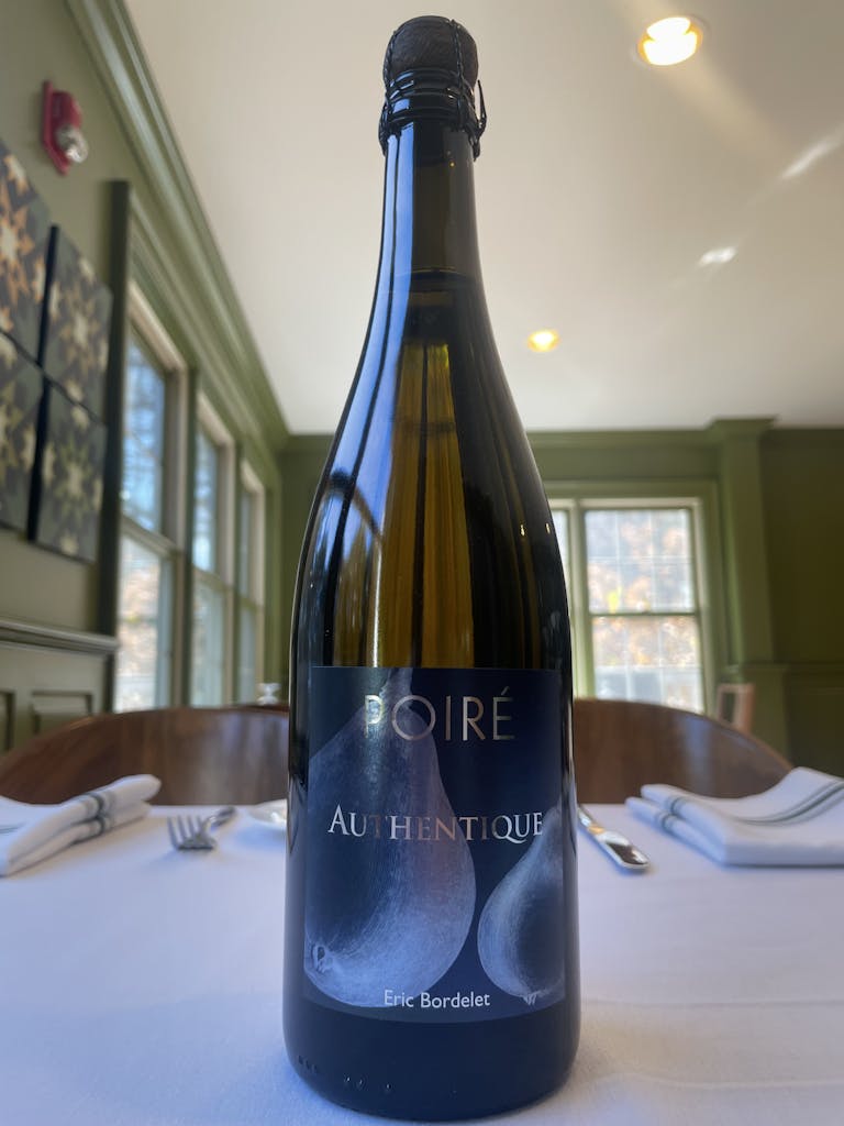 a bottle of wine and a glass of beer on a table
