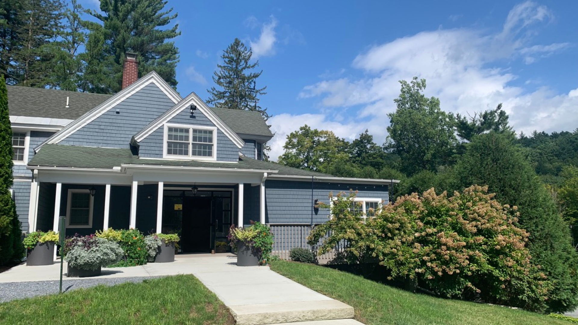 a house with bushes in front of a building