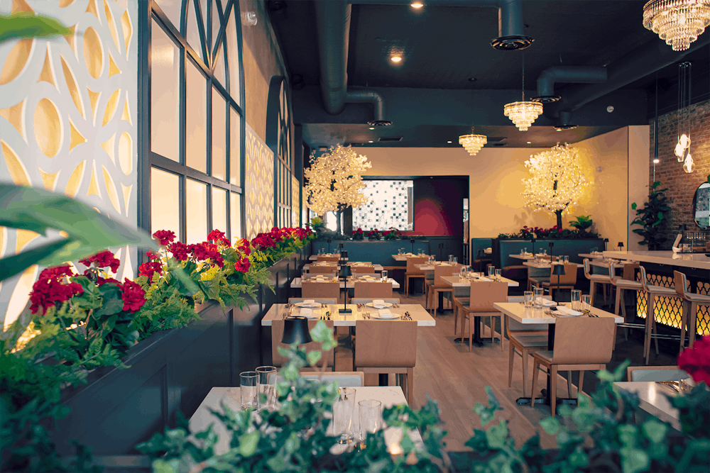 a room filled with furniture and vase of flowers on a table