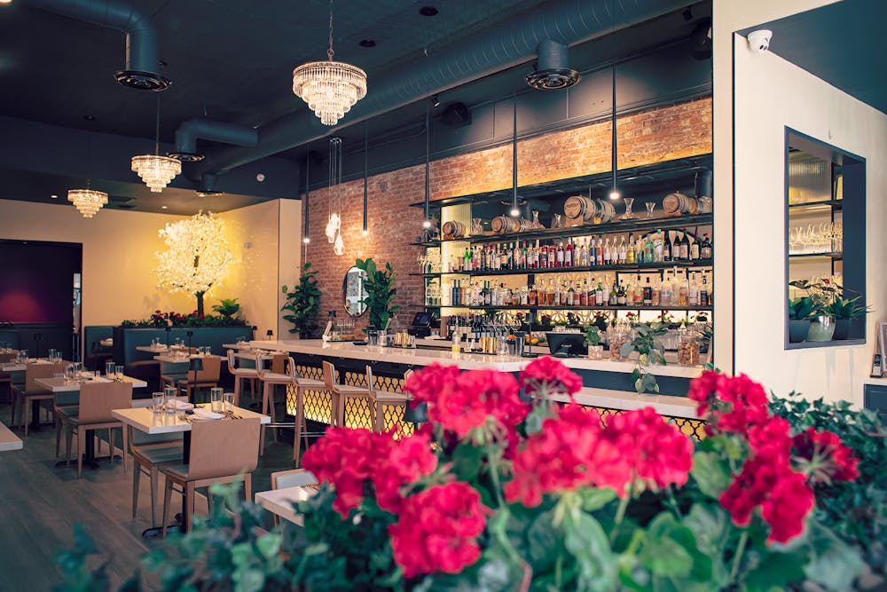 a room filled with furniture and vase of flowers on a table
