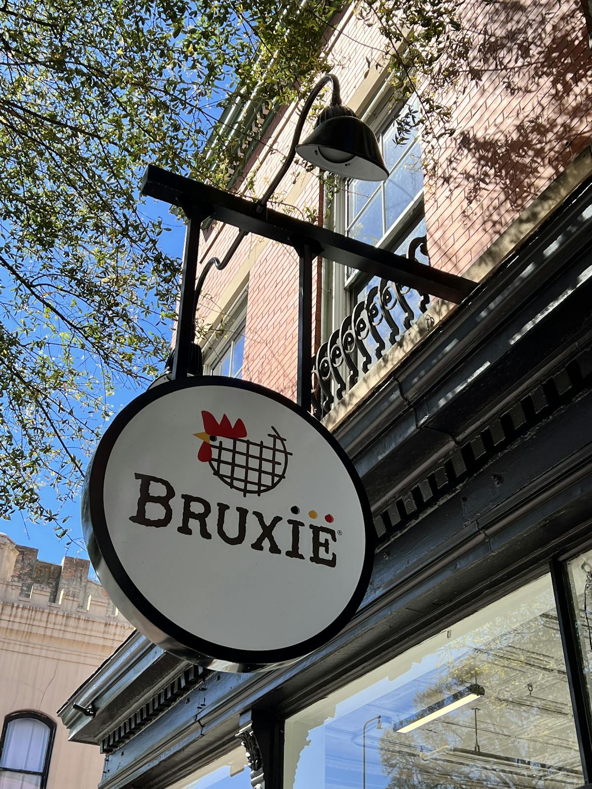 a sign hanging off the side of a building