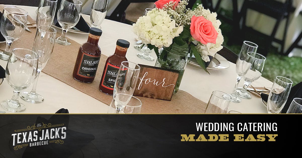a glass of wine and a vase of flowers on a table