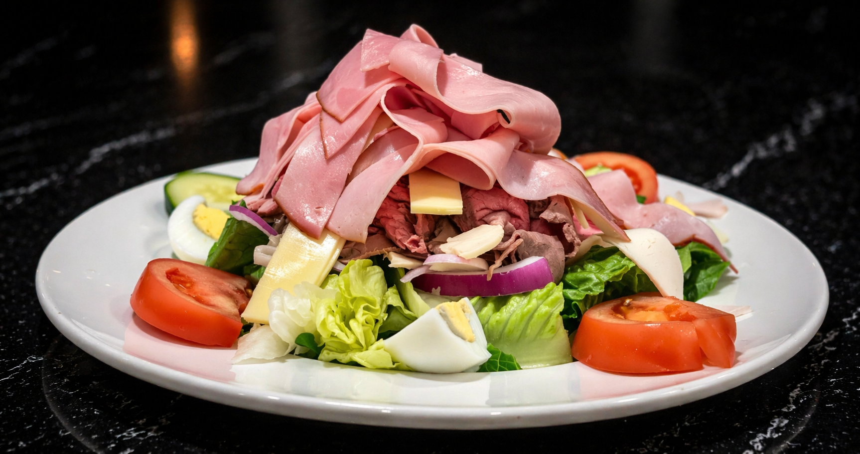 a plate of salad with meat and vegetables