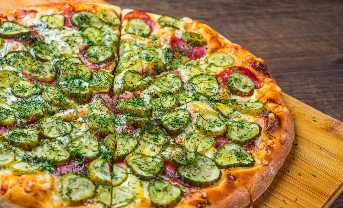 a pizza sitting on top of a wooden cutting board