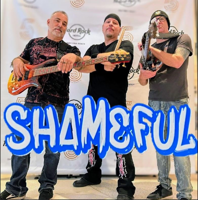 a group of people holding a sign posing for the camera