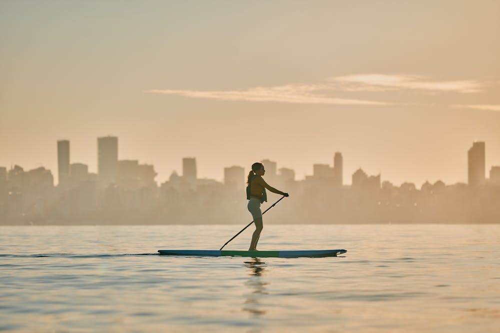 a group of people standing around a table with food