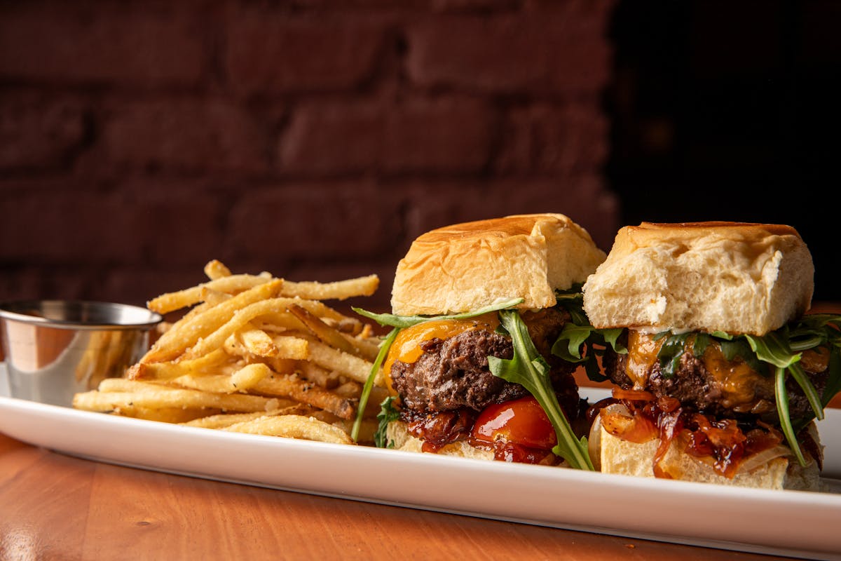 a plate of food with a sandwich and fries on a table