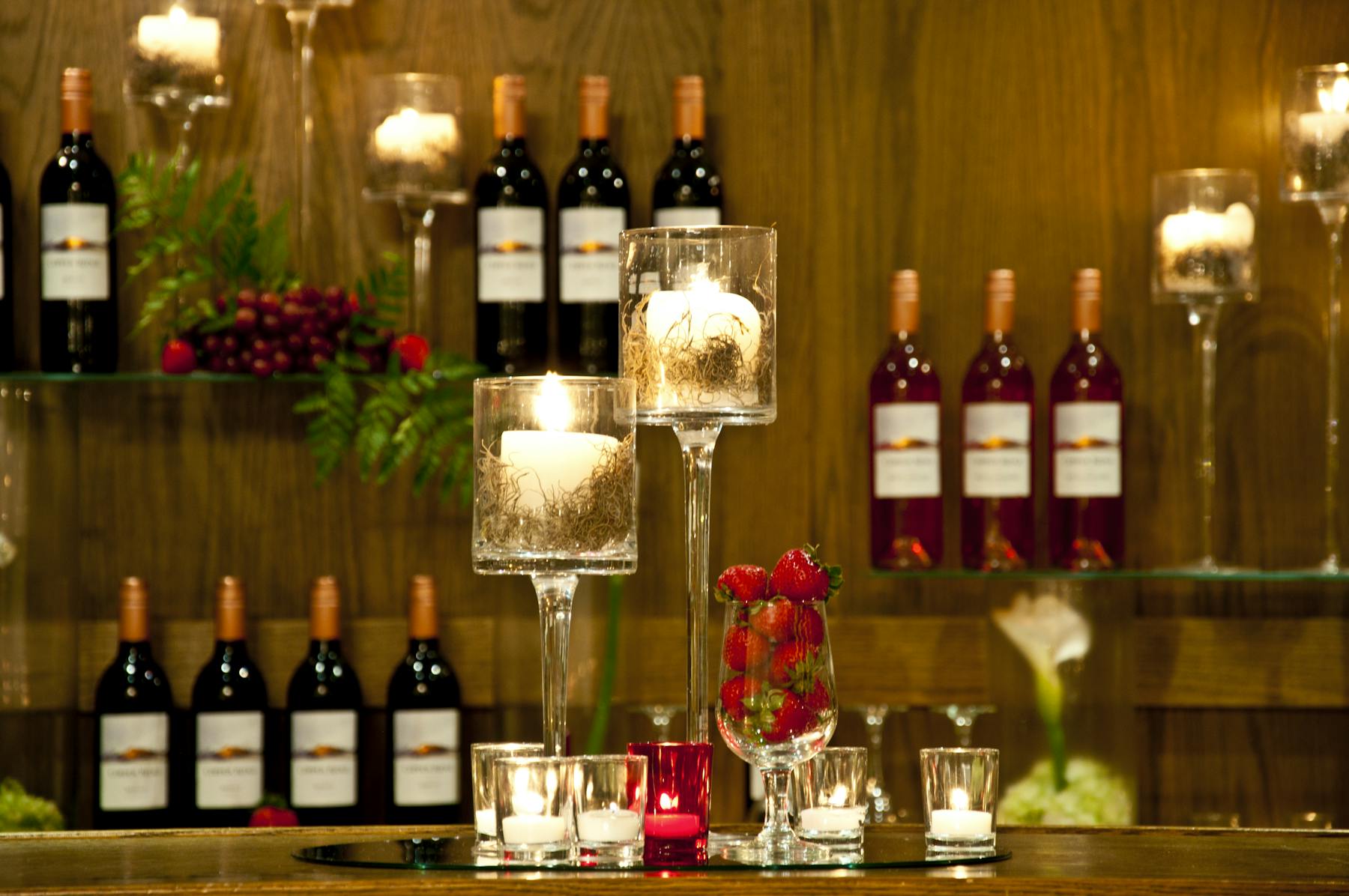 several bottles of wines on a wooden wall
