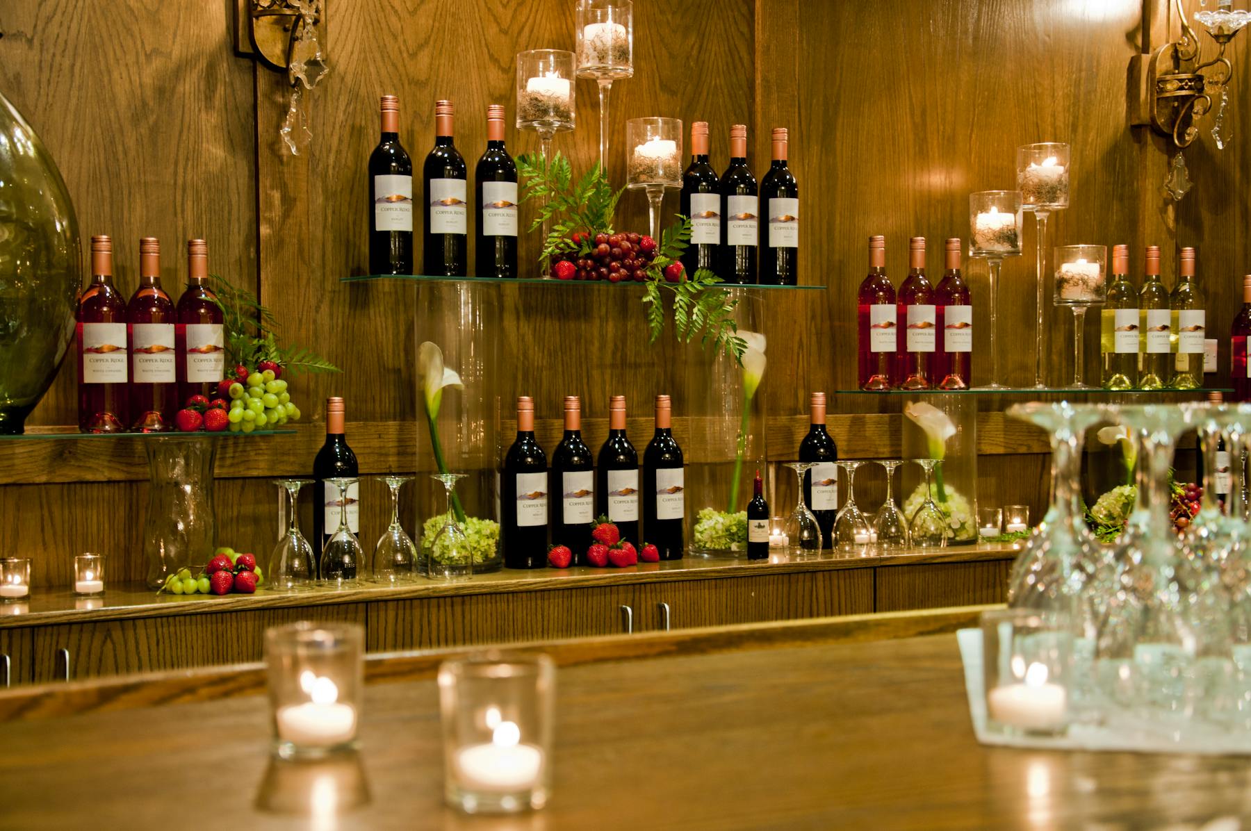 several bottles of wines on a wooden wall