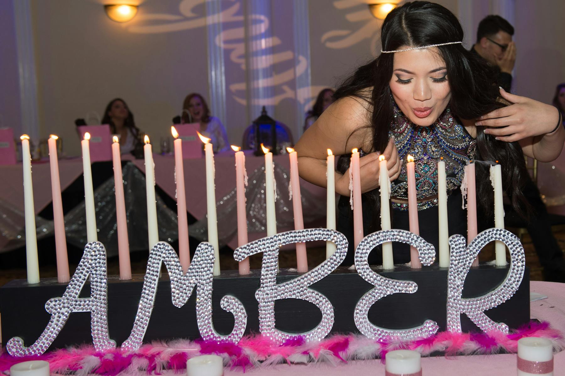 a woman blowing up candles on a cake